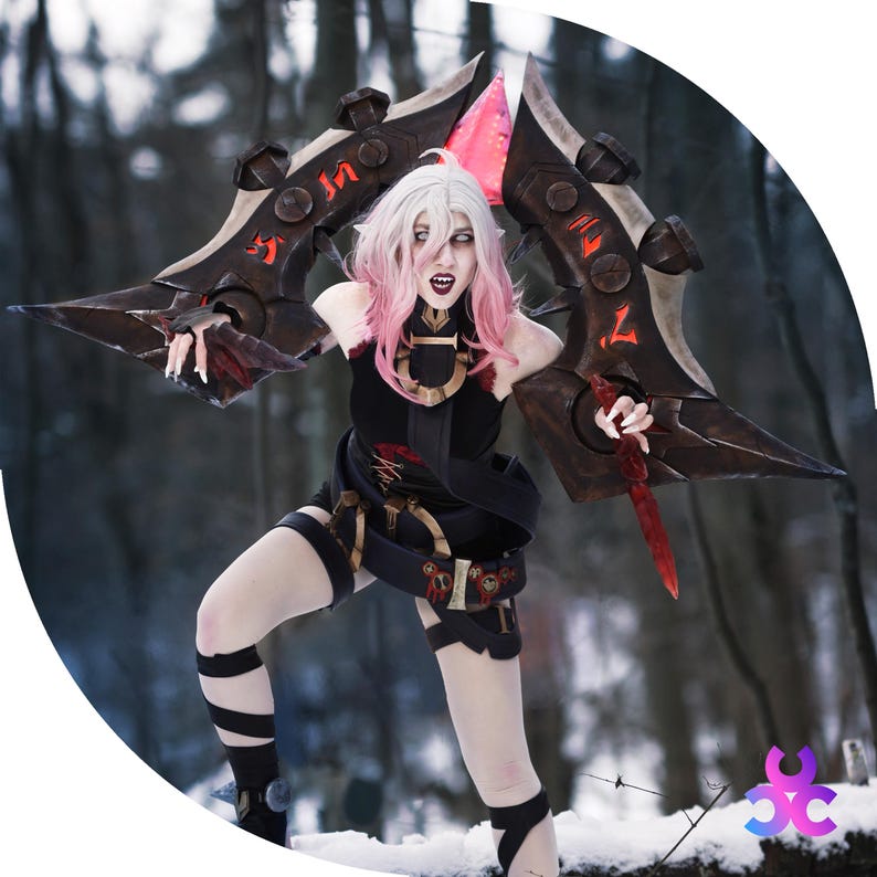May include: A person in a black costume with a large, ornate weapon. The weapon is dark brown with red accents and a pink blade. The person has white hair with pink highlights and is in a snowy outdoor setting.