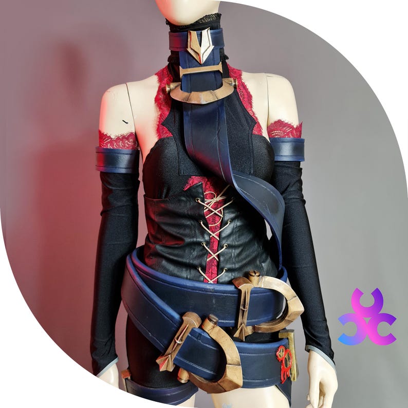 May include: A black and red cosplay costume displayed on a mannequin. The costume features a black top with red lacing and accents, a wide blue belt with gold-colored buckles, and matching armbands. The neckline and sleeves are trimmed with red lace.