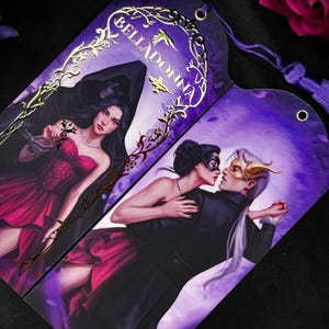 May include: Two decorative bookmarks with illustrations. One features a woman in a red dress with a skeleton figure, the other depicts a couple in formal attire. The word "BELLADONNA" is printed in gold.