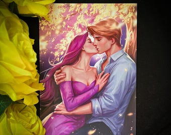 May include: A romantic illustration depicts a couple kissing under a tree with a golden, glowing background. The woman wears a purple dress, and the man is in a blue shirt. Yellow roses are in the foreground.