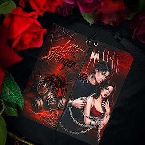 May include: Two rectangular bookmarks with dark red and black themes. One features a gas mask, a spider, and the text Little Stranger. The other shows a person with dark hair standing behind another person with long dark hair, with the text MINE.