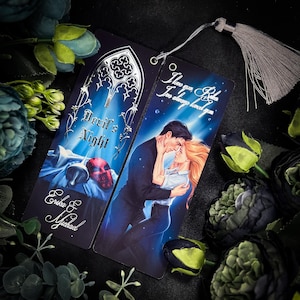 May include: A double-sided bookmark with a silver metallic finish. One side features a gothic-style illustration of a bell, a skull, and the text "Devil's Night". The other side features a couple embracing with the text "I love you,  Roka. I've always loved you."