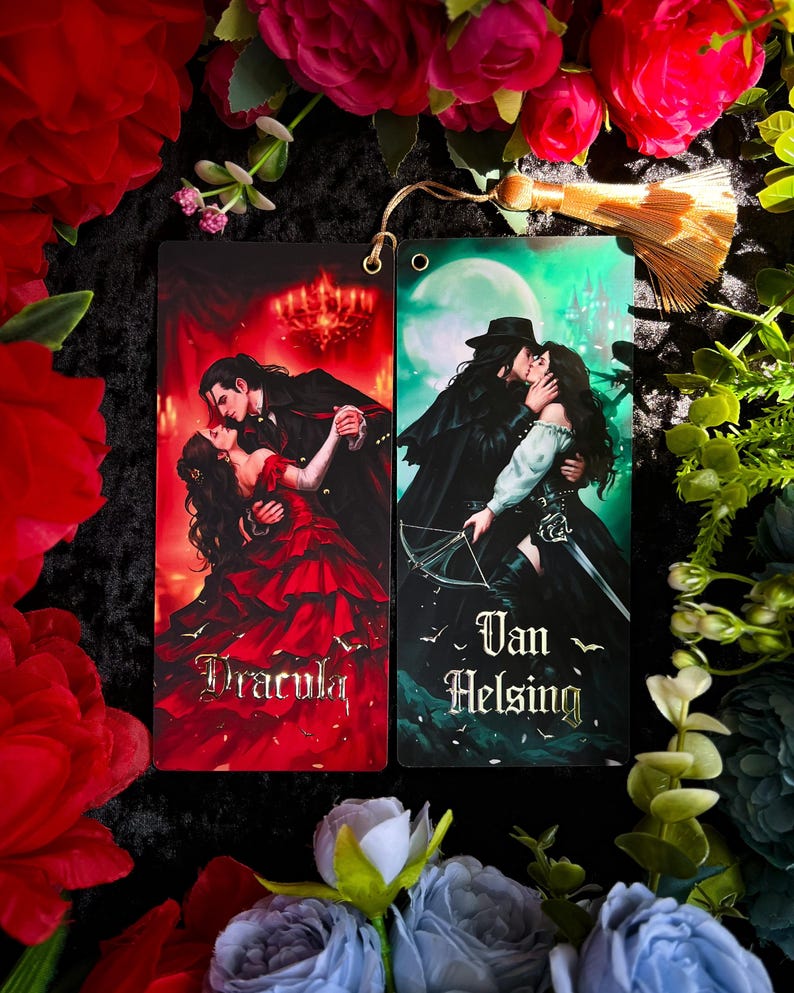 May include: Two rectangular bookmarks featuring romantic illustrations. One depicts a couple dancing with the word "Dracula", the other shows a couple kissing with the words "Van Helsing". Both have a hole at the top for a tassel.