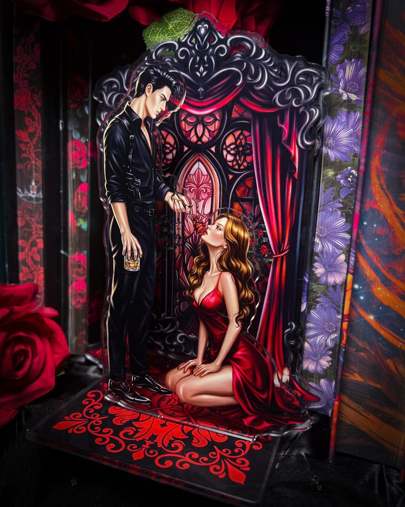 Puede incluir: Pieza de arte acr&iacute;lico que presenta a un hombre vestido de negro ofreciendo una rosa roja a una mujer con un vestido rojo. El fondo incluye un dise&ntilde;o de ventana g&oacute;tica con cortinas rojas y detalles florales. La base tiene un patr&oacute;n ornamental rojo y negro.