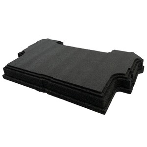 May include: A rectangular black foam insert with a textured surface and precision-cut edges. The foam piece features a stepped design with notched corners and indented sides, providing a structured shape for protective storage or organisational purposes.