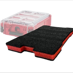 May include: A black and red foam insert for a tool organiser. The insert is rectangular with a textured black top and red sides. A red tool organiser with a clear lid is in the background.