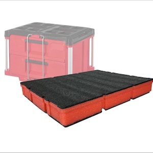 May include: A black foam insert with a red frame, designed for tool storage. The insert is rectangular with a textured surface. A red tool box is in the background.