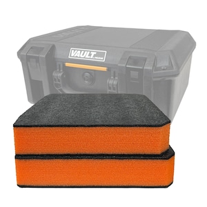 May include: Two orange and black foam pads are stacked in front of a black Pelican Vault case. The pads have a black top and bottom with orange sides. The case is black with the word "VAULT" printed on it.