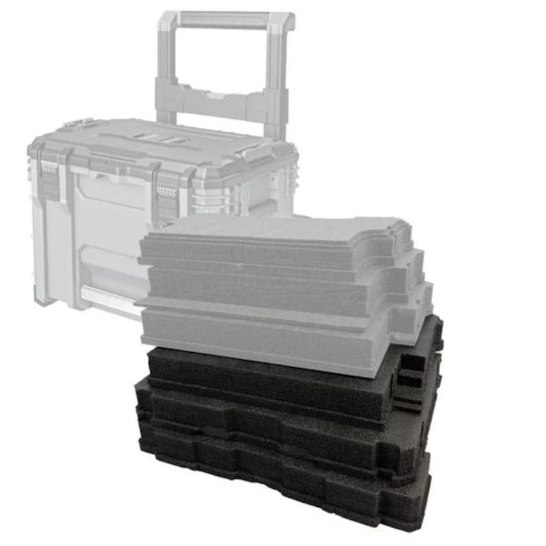 May include: A stack of rectangular foam inserts in black and light grey, featuring precision-cut contours and stepped edges. Behind the foam stack is a semi-transparent, ghosted outline of a rolling tool box with a retractable handle and latches.