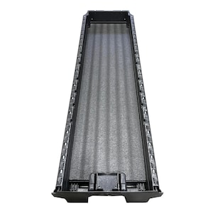 May include: A long, rectangular black plastic tray featuring a textured, corrugated interior base. The side walls are constructed with a series of evenly spaced vertical slots and structural ribs, providing a rigid frame for this storage container.