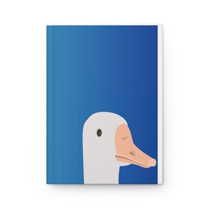 May include: A white goose head with a blue background. The goose has a pink beak and a black eye.
