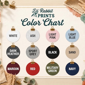 The image is a color chart with twelve different color options, each represented by a round circle with a color name written inside. The chart is surrounded by various decorative elements such as leaves, flowers, and gold binder clips, creating a visually appealing and organized presentation of the color options.