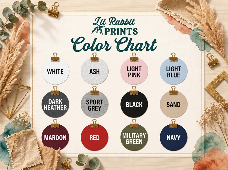 The image is a color chart with twelve different color options, each represented by a round circle with a color name written inside. The chart is surrounded by various decorative elements such as leaves, flowers, and gold binder clips, creating a visually appealing and organized presentation of the color options.