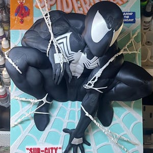 May include: A three-dimensional wall art piece featuring a black Spider-Man figure in a crouching pose against a light blue comic book cover background. The cover includes the text Marvel Comics, 13th All-New Collectors Item Issue, Spider-Man, Legend the Knight, and Sub-City Part One of Two, with white web accents.