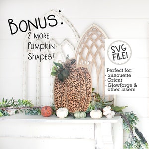 May include: A wooden pumpkin with a leopard print design. The pumpkin is sitting on a white mantel with other pumpkins and greenery. The text "BONUS: 2 MORE Pumpkin SHAPES!" is above the pumpkin. The text "SVG FILE!" is in a circle above the text "Perfect for: Silhouette Cricut Glowforge & other lasers".
