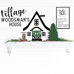 May include: Black and white silhouette of a village house with a wreath on the door, a Christmas tree, and a sled. The text "Village Woodsman's House" is above the house. The text "SVG FILE! Perfect for: Silhouette Cricut Glowforge & other lasers" is in a white box with a black circle containing the text "SVG FILE!" in the upper right corner.