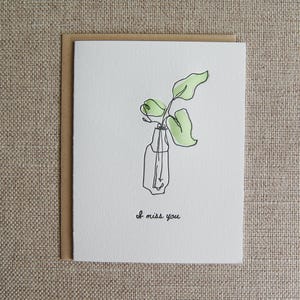 Tu me manques, carte typographique de dessin au trait de vase de bourgeon