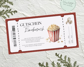 May include: A movie ticket gift certificate with a red border, featuring a popcorn bucket graphic. The ticket includes text in German, a barcode, and spaces for "FÜR" and "VON" names. The ticket is decorated with sprigs of greenery.