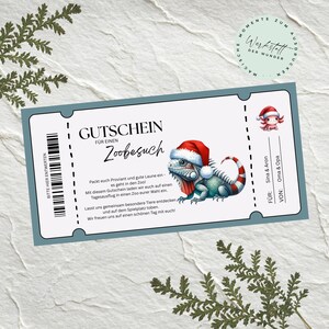 May include: A German-language zoo visit gift voucher. The voucher features a cartoon iguana in a Santa hat. It includes a barcode, and spaces for the recipient and giver. The design is set against a light blue background with decorative elements.