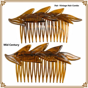 May include: A pair of vintage hair combs with a Mid Century design. Each comb features a leaf-like design in shades of brown and amber. The text "Pair - Vintage Hair Combs" and "Mid Century" are visible.