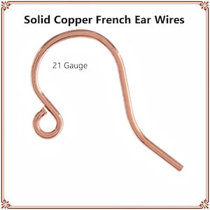 May include: A solid copper French ear wire with a curved hook shape and a small loop at the bottom for attachment. The text Solid Copper French Ear Wires and 21 Gauge is printed on the image, indicating the material and wire thickness.