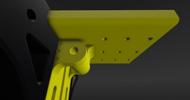 May include: A yellow plastic bracket with a series of holes and a rounded hinge. The bracket is attached to a black plastic piece.