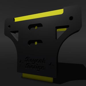 May include: Black plastic wall mount with a yellow stripe and the text "Raywork Design" printed on the front.