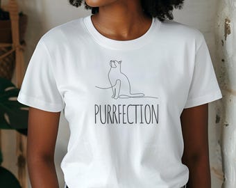 May include: White t-shirt with a line drawing of a cat and the text "PURRFECTION" printed on the front.