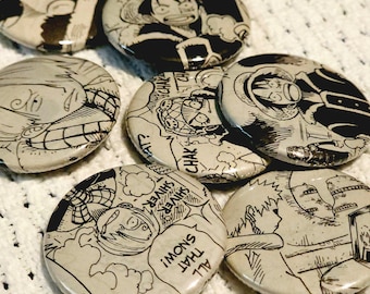 May include: A set of eight black and white anime character button pins. The pins feature different characters from the anime series "One Piece". The text on the pins reads "All That Snows I'm on Shiver Shiver Chack Chack".