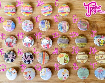 May include: A collection of colorful, round pinback buttons with various designs, including cartoon characters, rainbows, and text. The buttons are arranged on a wooden surface, showcasing a variety of styles and themes.
