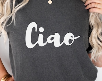 May include: A dark gray t-shirt with the word "Ciao" written in white cursive lettering.