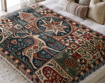 May include: A woven throw blanket featuring a multi-panel design with a central deer, a large star, a gingerbread house, a pinecone, and a mitten. The pattern includes festive botanical motifs, holly berries, and geometric borders in deep red, blue, and green.