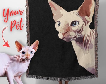 May include: A black woven throw blanket with a white hairless cat printed on it. The cat is looking to the right of the image. The blanket has fringe around the edges.