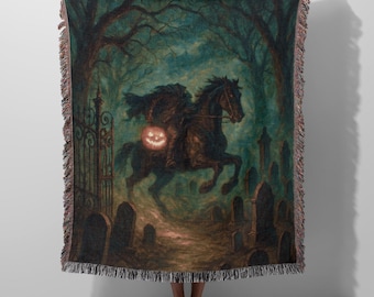 May include: A woven throw blanket featuring a spooky illustration of the Headless Horseman riding a black horse through a graveyard. The artwork has a dark, eerie color palette with a pumpkin lantern.