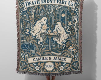 May include: A woven throw blanket featuring a dark blue and cream illustration of two ghosts having tea in a greenhouse. The text reads DEATH DIDN'T PART US, CAMILE & JAMES, and 2026. The design includes a cat, plants, and skulls.