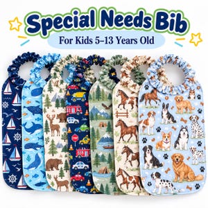 May include: A collection of seven fabric bibs for kids 5-13 years old, each featuring a unique pattern including sailboats, whales, forest animals, emergency vehicles, mountain landscapes, horses, and various dog breeds with ruffled neck collars.