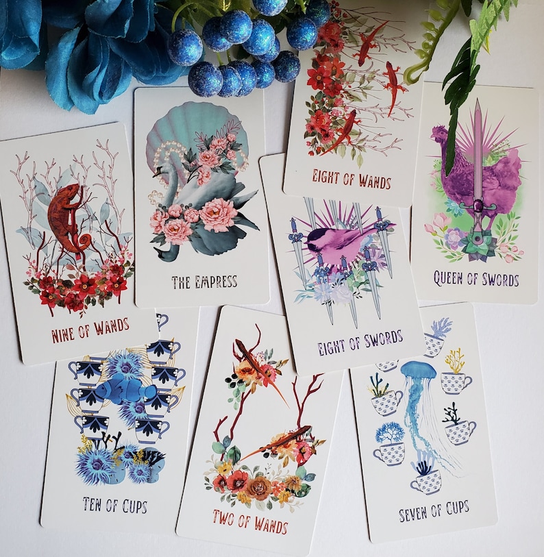 May include: A set of ten tarot cards with colorful illustrations and text. The cards include Nine of Wands, The Empress, Eight of Wands, Eight of Swords, Queen of Swords, Ten of Cups, Two of Wands, and Seven of Cups.