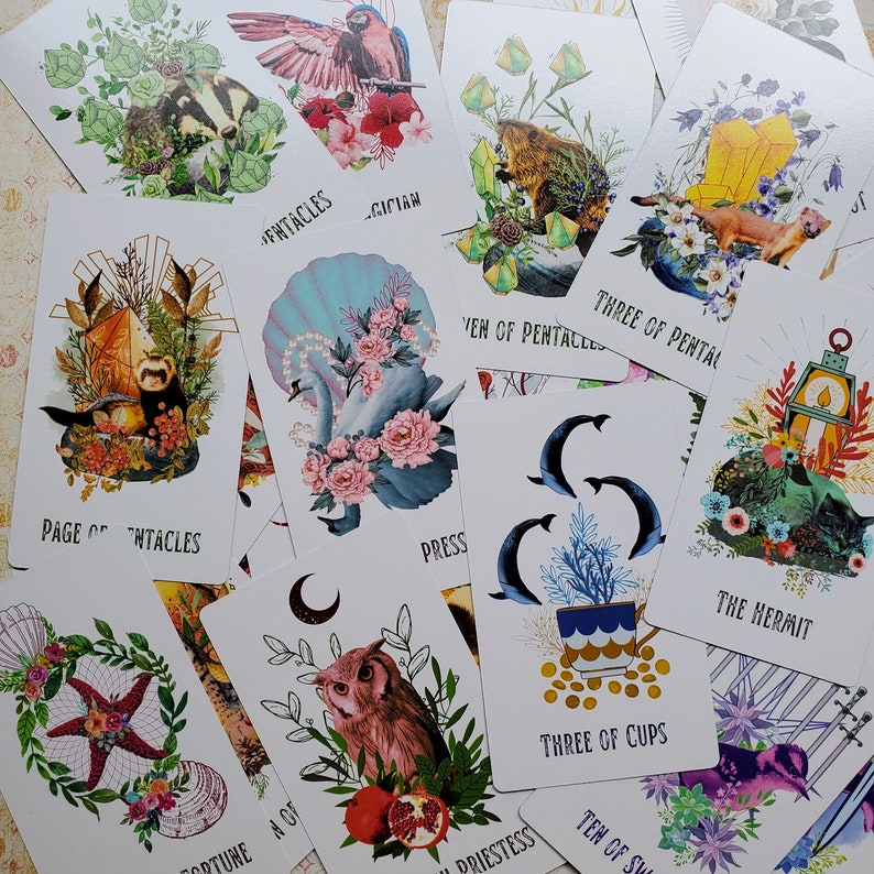 May include: A set of 10 tarot cards featuring colorful illustrations with various themes, including a mermaid, a hermit, a cup, and a pentacles. The cards are printed on thick cardstock with a matte finish.