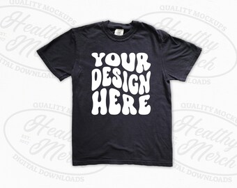 May include: A black t-shirt with the text "YOUR DESIGN HERE" in white, stylised lettering.