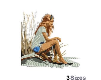 May include: An embroidered design featuring a person sitting on a log near tall grass. The person is wearing a light blue t-shirt and denim shorts. The design is in shades of brown, blue, and tan. The text "3 Sizes" is at the bottom.