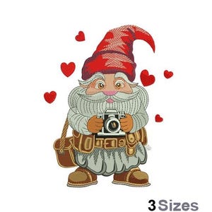 May include: A red and white gnome with a white beard and a camera is holding a camera. The gnome is surrounded by red hearts.