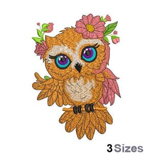 May include: Embroidered design of a cute orange owl with pink flowers and blue eyes. The owl is perched on a branch with its wings spread out.