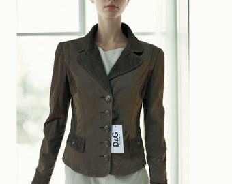 May include: A brown leather jacket with a corduroy collar and a D&G label. The jacket has a button closure and a fitted silhouette.