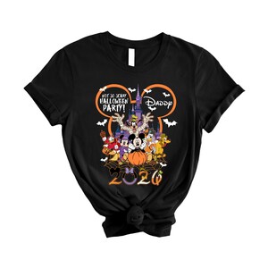 May include: A black short-sleeve t-shirt featuring a graphic of Disney characters in Halloween costumes. The design includes the text "NOT SO SCARY HALLOWEEN PARTY!" and "DADDY" inside a Mickey Mouse ear outline, with "2026" at the bottom.