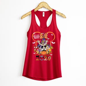 May include: A red racerback tank top featuring a graphic of Disney characters in Halloween costumes, a castle, and the text "Not So Scary Halloween Party! 2020". The design includes a large orange pumpkin, a polka dot bow, and white bats.