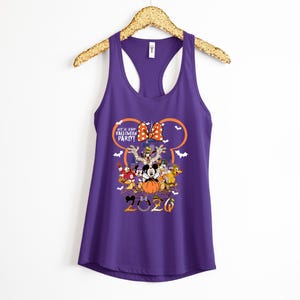 May include: A purple racerback tank top featuring a graphic of Disney characters in Halloween costumes, a pumpkin, and a castle silhouette. The text reads Not So Scary Halloween Party and 2020, framed by an orange Mickey Mouse ear outline.