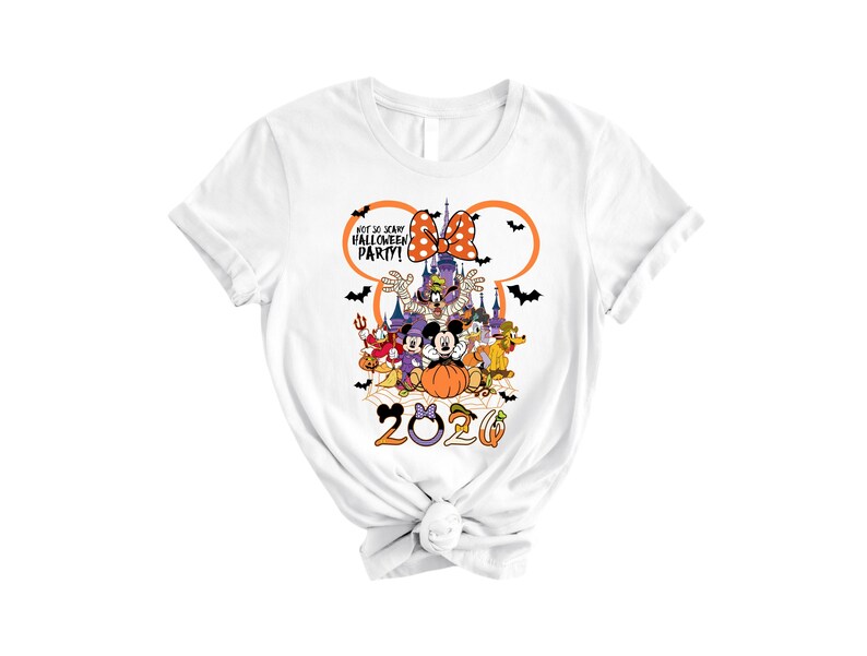 May include: A white t-shirt featuring a graphic of Disney characters in Halloween costumes, a castle, and the text "NOT SO SCARY HALLOWEEN PARTY!" inside a Mickey Mouse ear outline. The year "2020" is printed at the bottom with orange and purple accents.