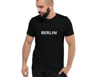May include: A black t-shirt with the word "BERLIN" printed in white on the front.