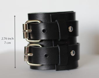 May include: Black leather double buckle bracelet with silver hardware. The bracelet is 2.76 inches in length.