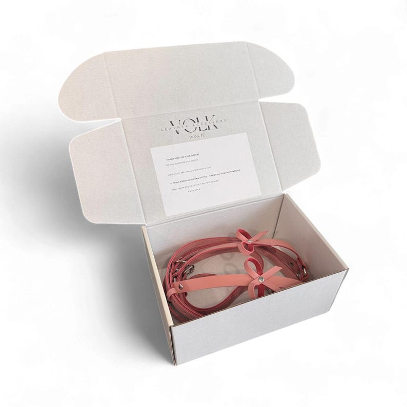 Leather thigh harness gift set in branded VOLK box, handmade garter belt packaging, ready to gift leather accessory, elegant minimalist white box presentation